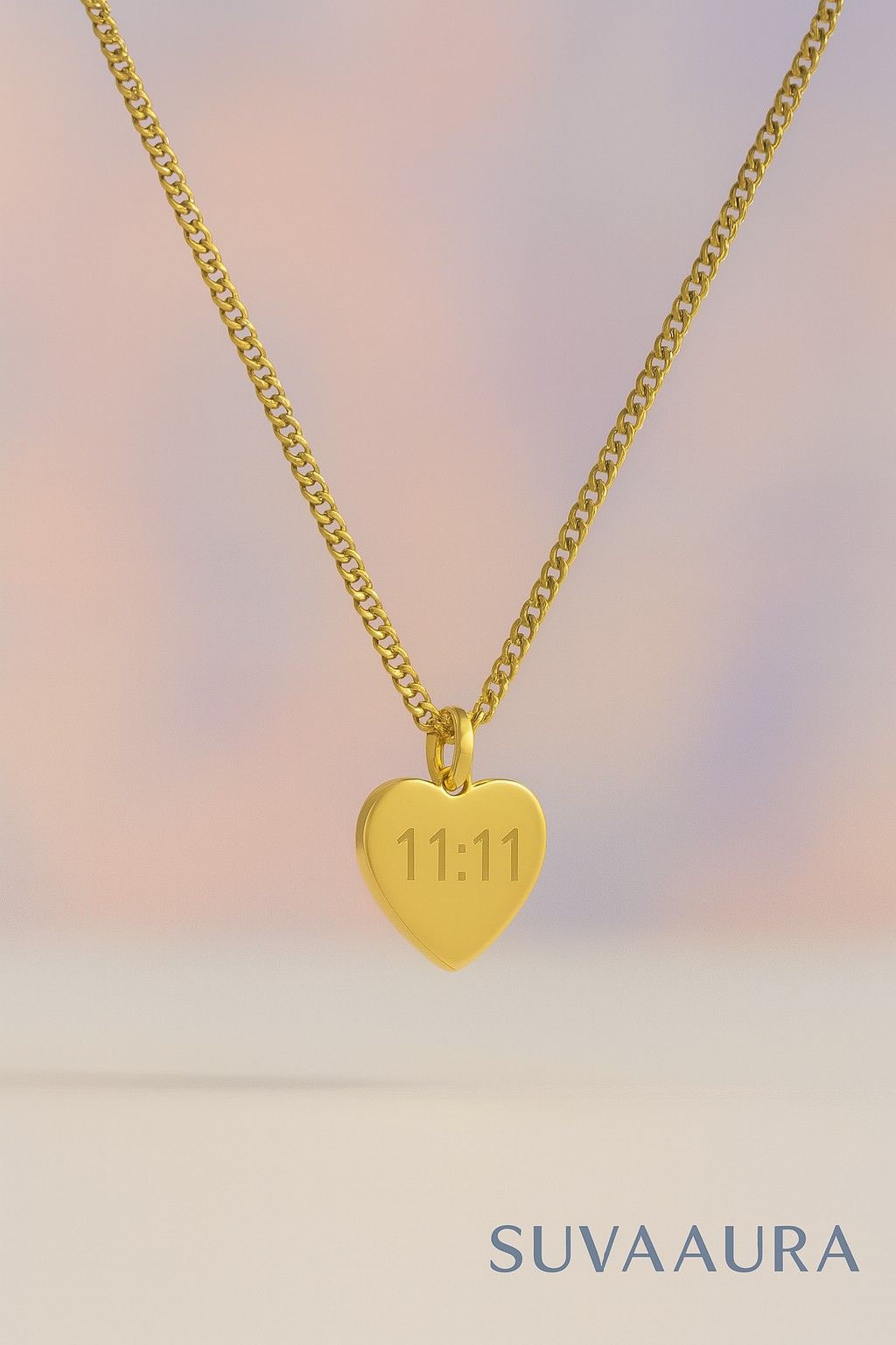 Gold heart-shaped pendant necklace with engraved 11:11 angel number on pastel background – minimalist style from Suvaaura