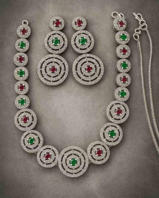 Dual tone necklace set with ruby & emerald AD stones in circular silver-tone design – includes matching earrings