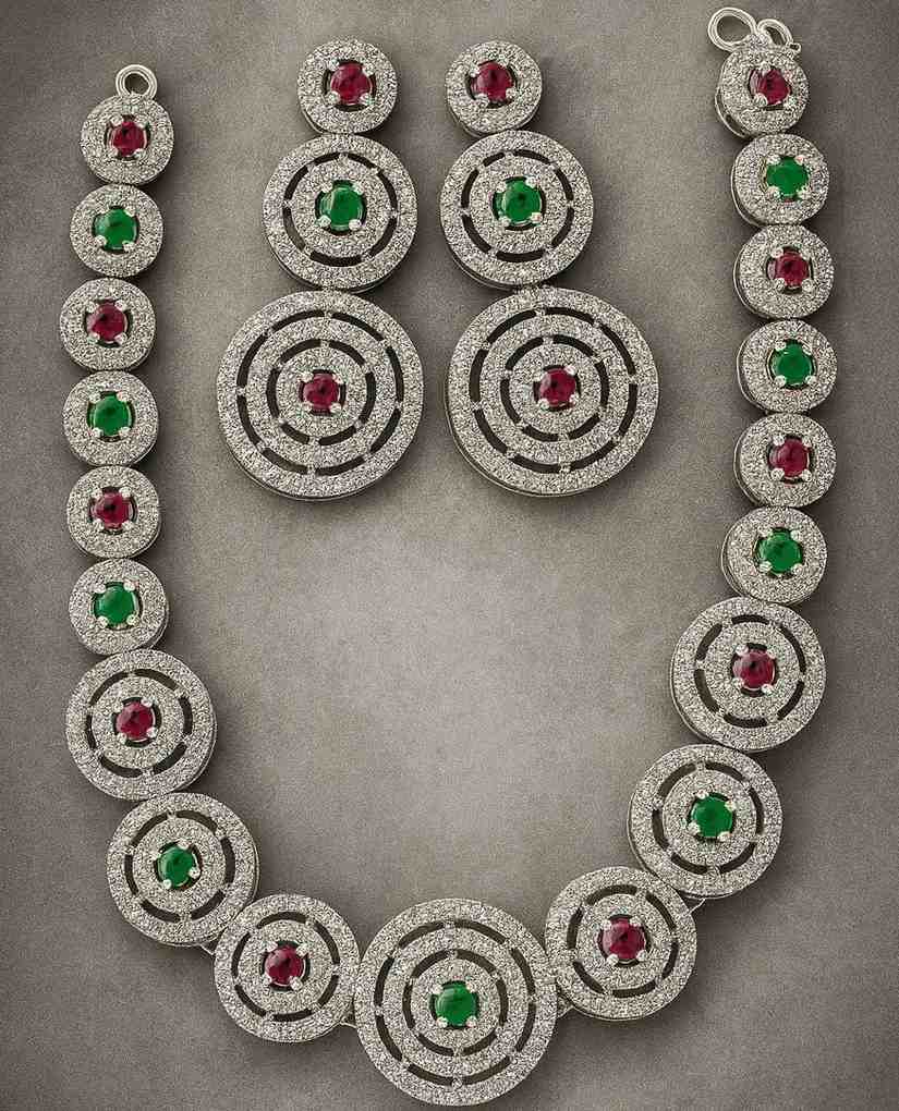 Dual tone necklace set with ruby & emerald AD stones in circular silver-tone design – includes matching earrings