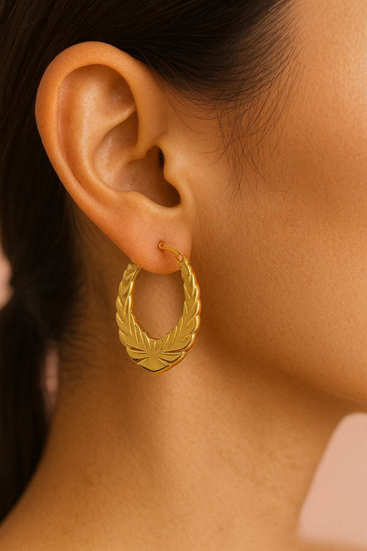 Close-up of woman wearing royal gold leaf earrings – traditional and modern fusion by Suvaaura