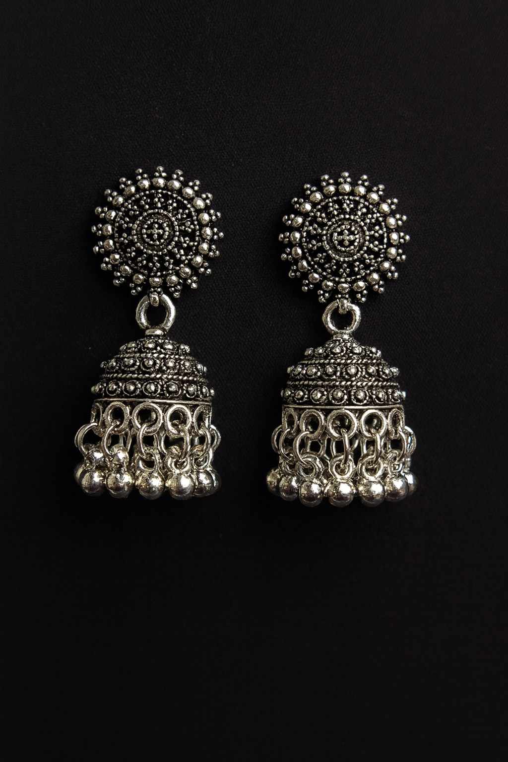 Antique oxidized silver-tone circular stud jhumka earrings front view