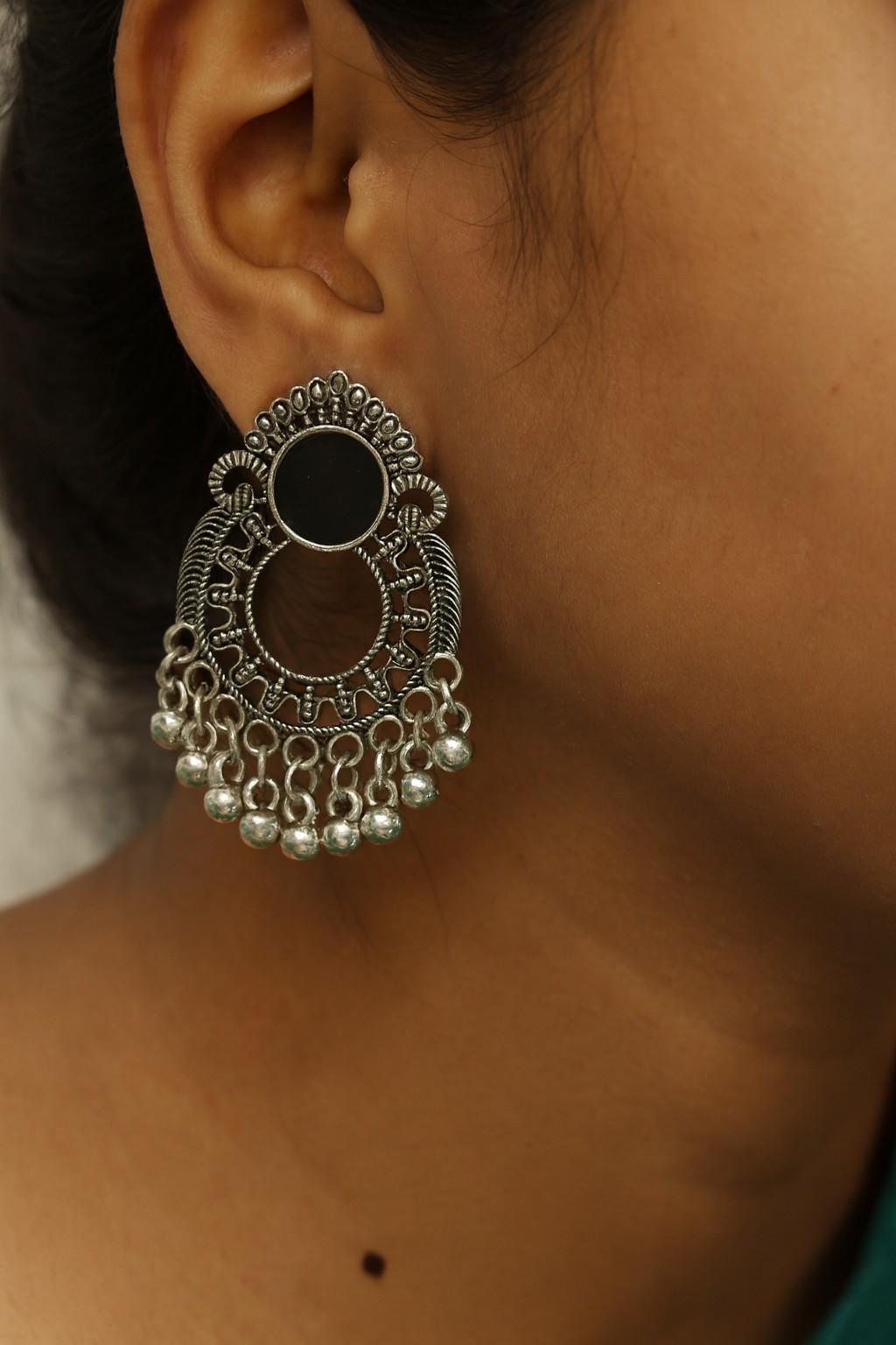 Model wearing oxidized silver-tone open hoop jhumka earrings with ghungroo drops