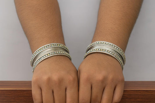 Elegant silver bangles stacked on wrist with shimmering crystals