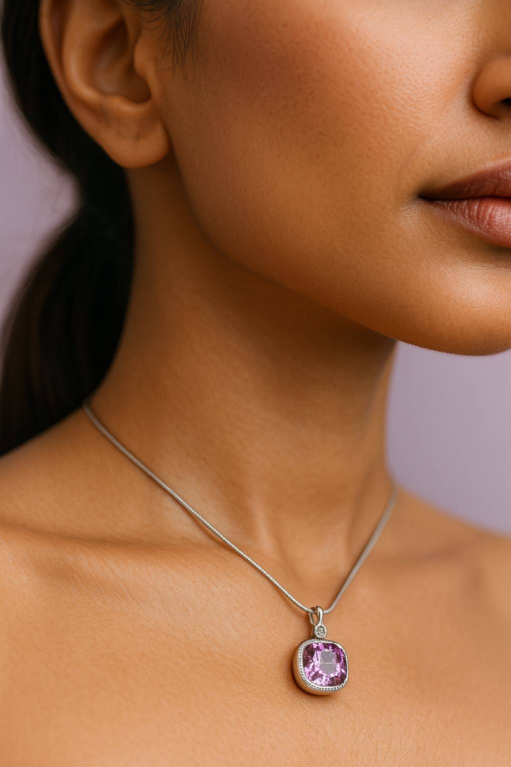 "Model wearing silver-tone square pendant necklace with pink stone – Suvaaura"