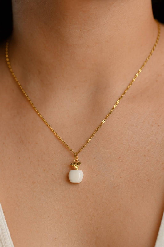 "Model wearing gold-tone white apple pendant necklace – Suvaaura"