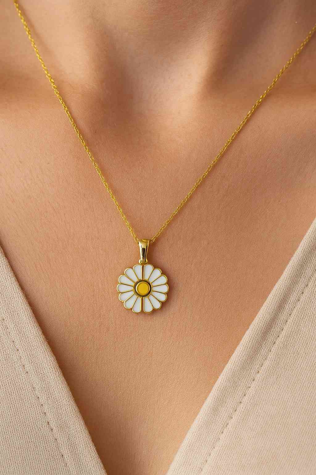 "Model wearing gold-tone daisy flower pendant necklace – Suvaaura"