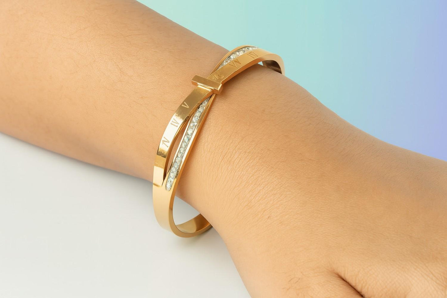 Elegant Roman numeral gold-tone bracelet on wrist with crystal accents