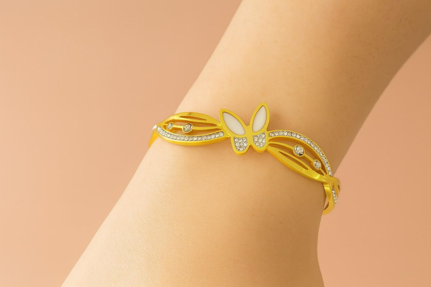 Elegant butterfly gold-tone bracelet on wrist with sparkling stones