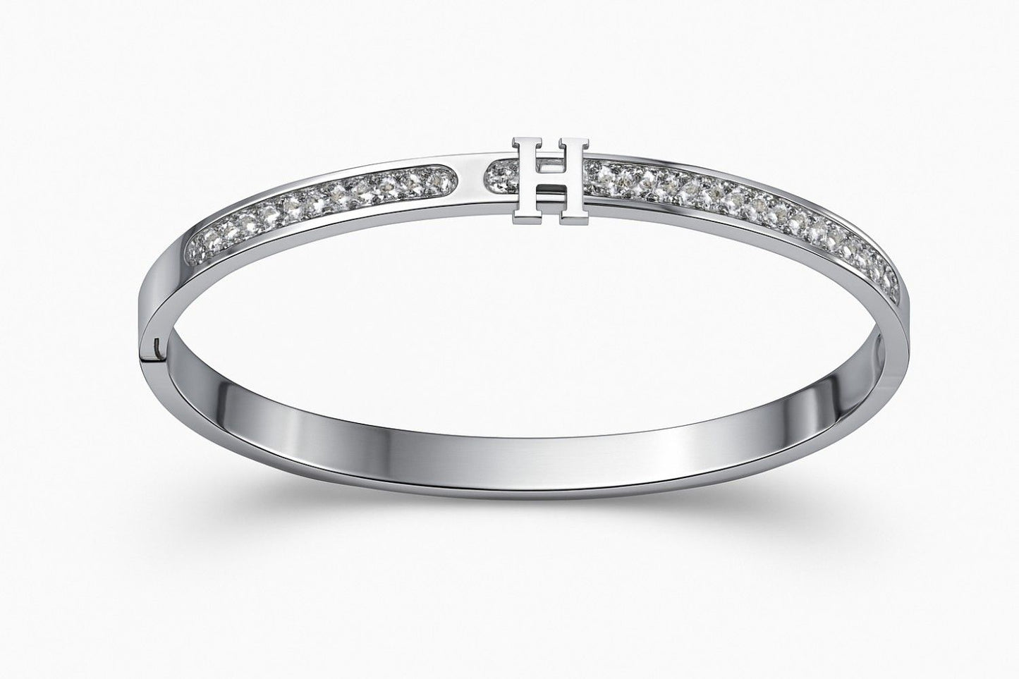 Elegant silver-colored bracelet with 'H' centerpiece on white background