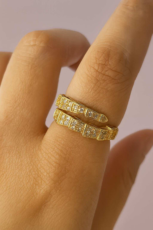 "Model wearing gold-tone double band crystal ring with adjustable fit"