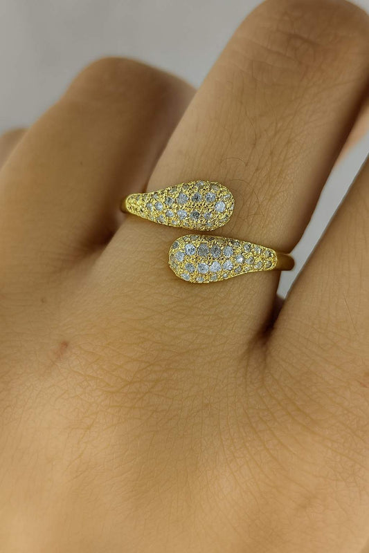 "Model wearing gold-tone teardrop crystal ring with adjustable fit"