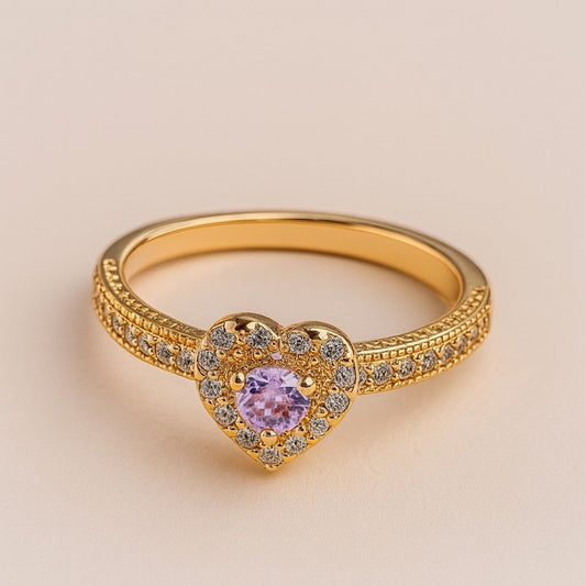 "Gold-tone heart-shaped ring with pink center stone and crystal halo"