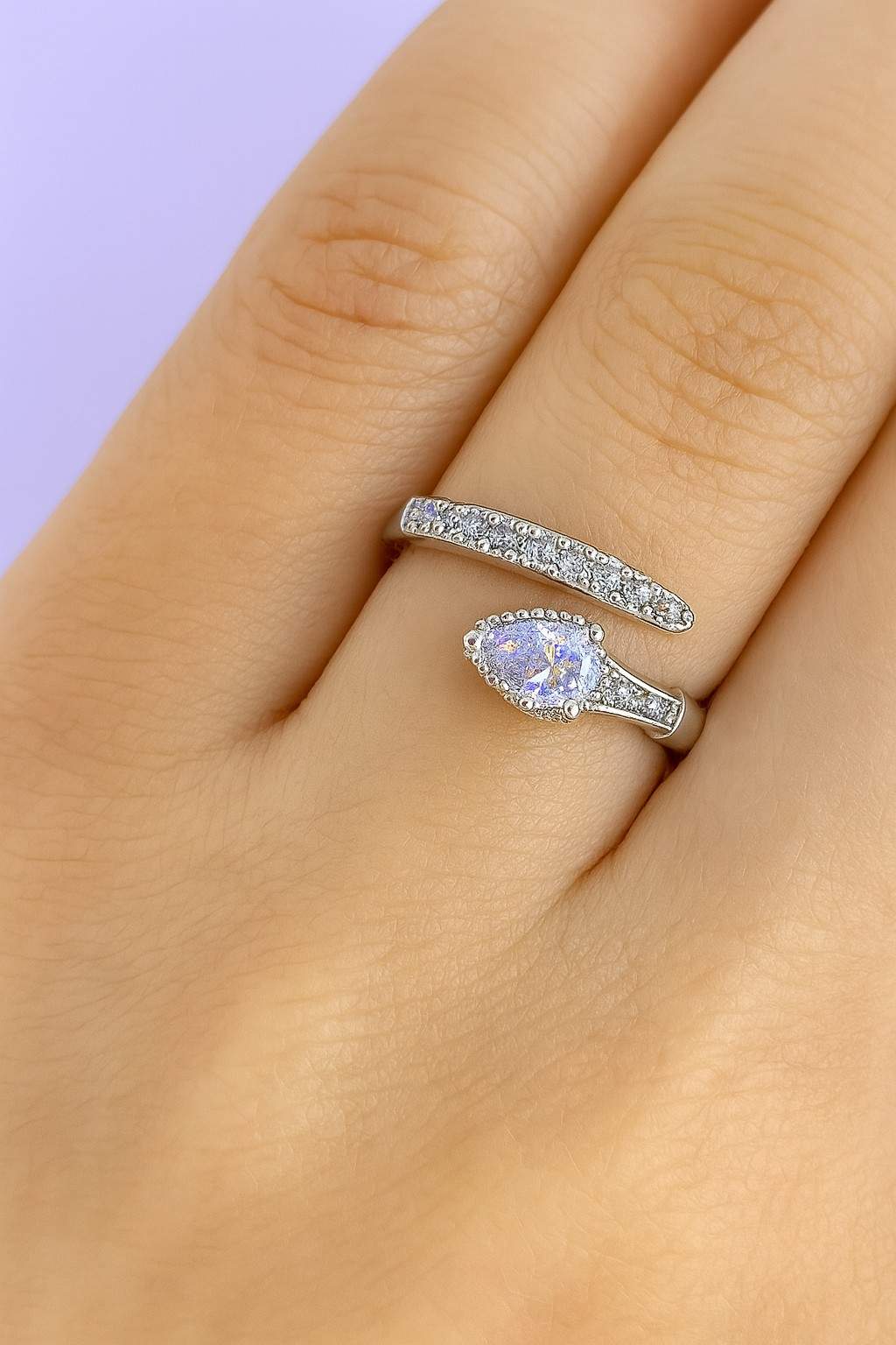 "Model wearing silver-tone teardrop crystal ring with adjustable fit"