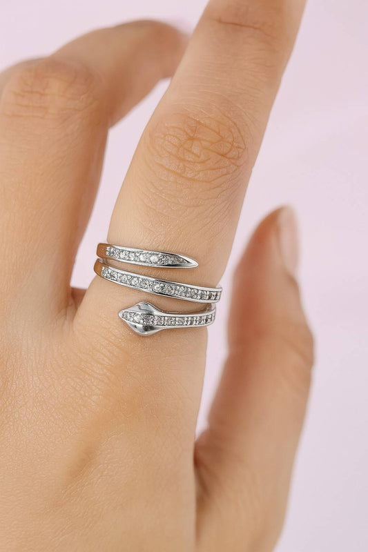 "Model wearing silver-tone snake wrap ring with adjustable fit and crystals"