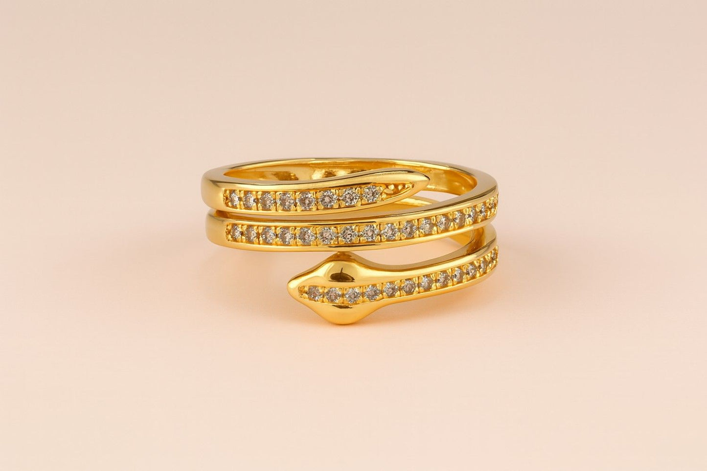 "Model wearing gold-tone snake wrap ring with crystal-studded design"