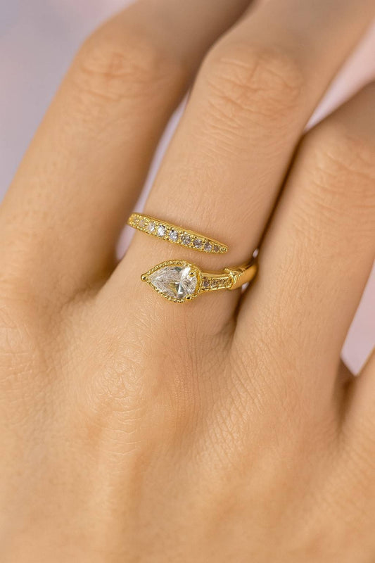 "Model wearing gold-tone teardrop crystal ring with adjustable fit"