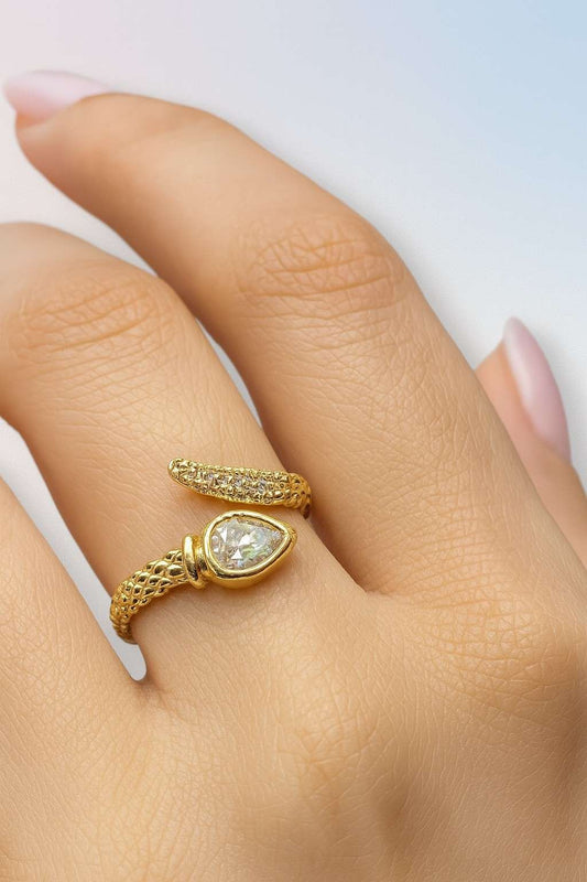 "Model wearing gold-tone textured teardrop crystal ring with adjustable fit"
