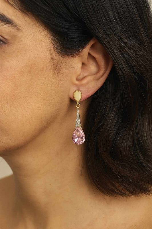 old-tone teardrop pink crystal dangle earrings worn on ear – model side view