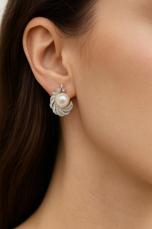"Model wearing silver-tone feather pearl stud earrings"