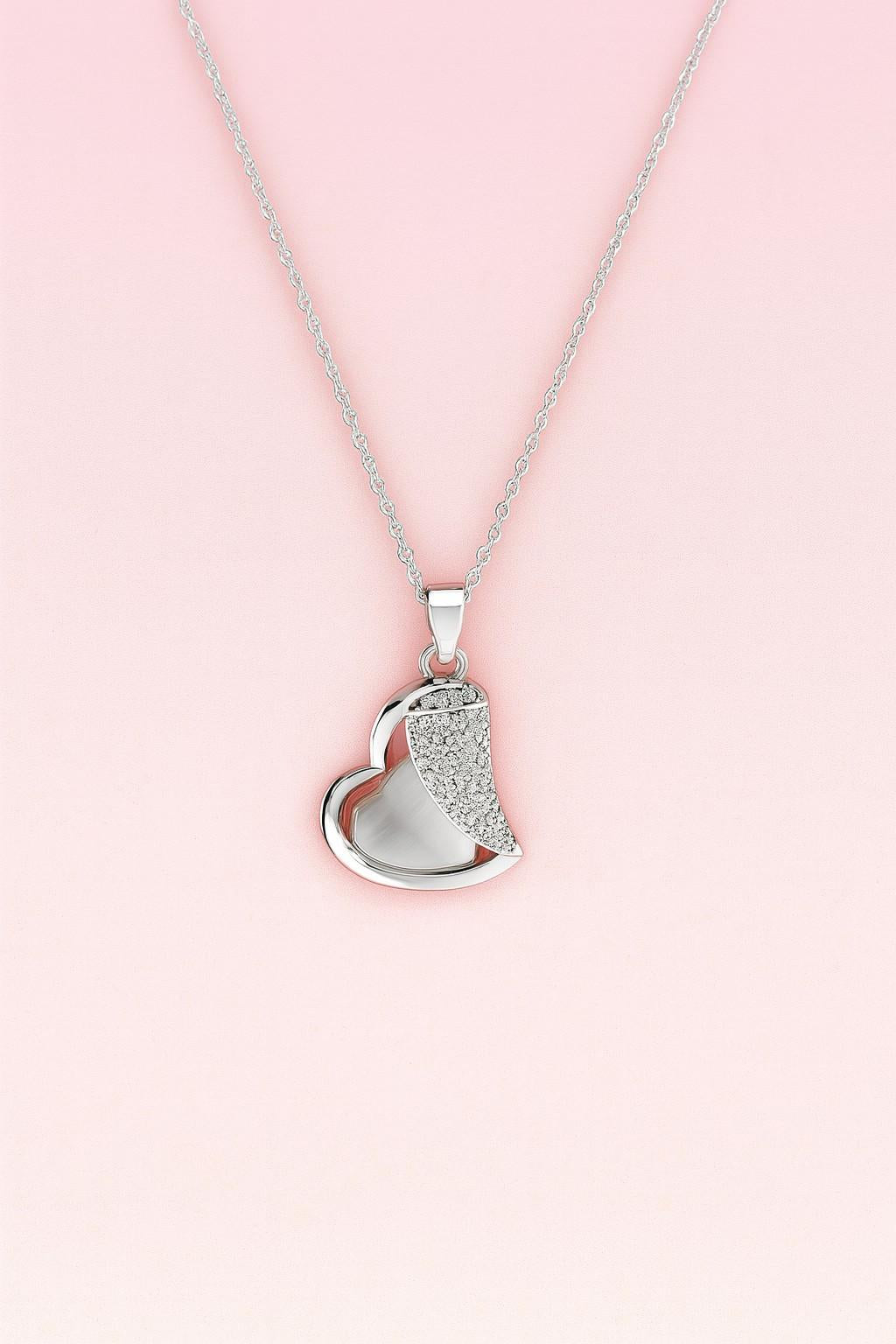 Silver-tone heart pendant necklace with crystal accents on pink background