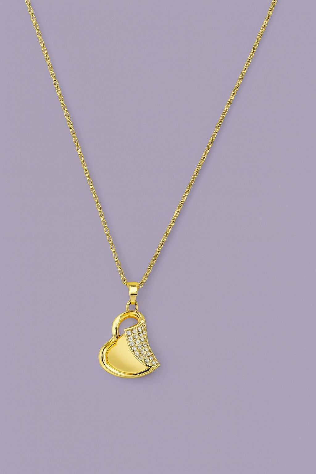 Gold-tone heart pendant necklace with sparkling crystals on a chain – product close-up