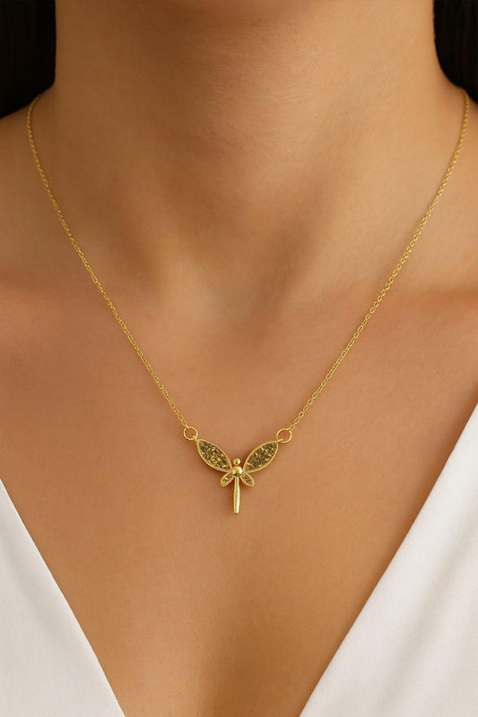 Elegant butterfly wing pendant necklace worn with gold-tone chain around neck