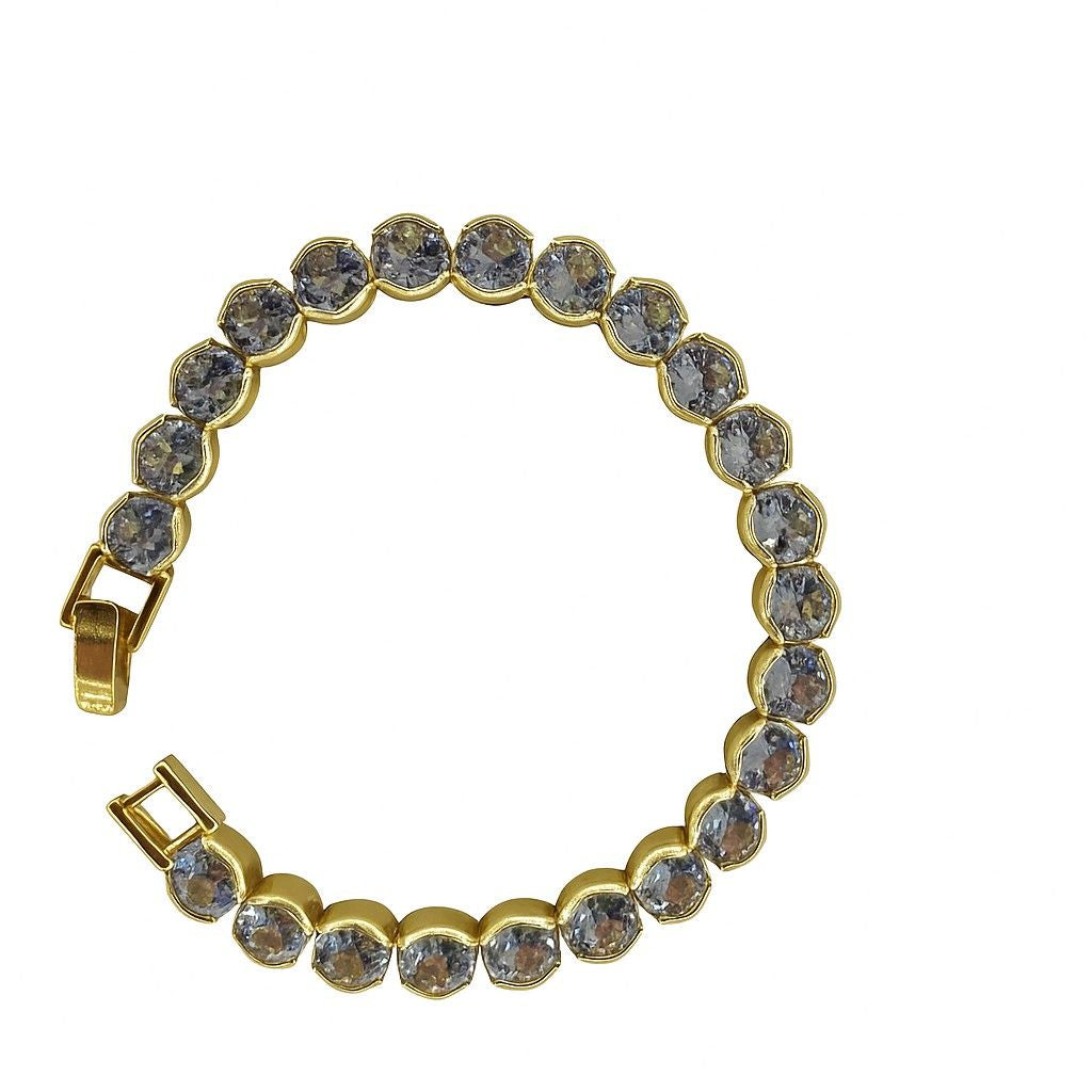 Round-cut crystal tennis bracelet in gold-tone setting on white background