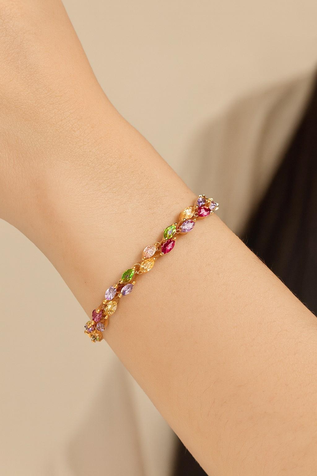 Elegant multicolor marquise-cut crystal bracelet worn on wrist with gold-tone finish