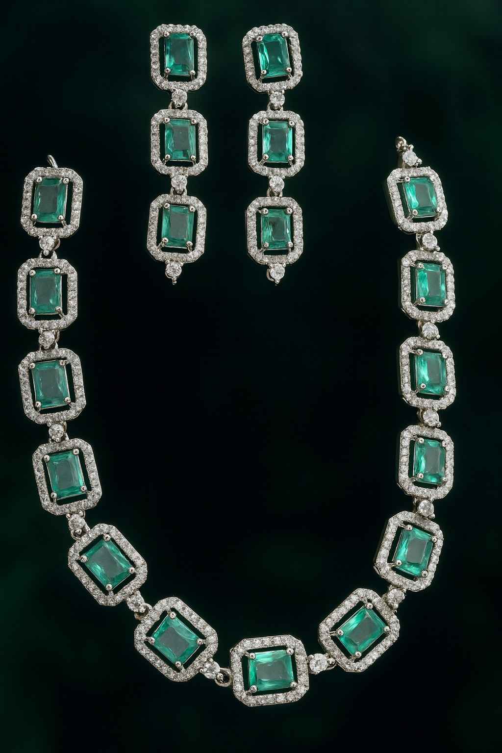 Green American Diamond necklace set with earrings in silver-tone finish on dark background
