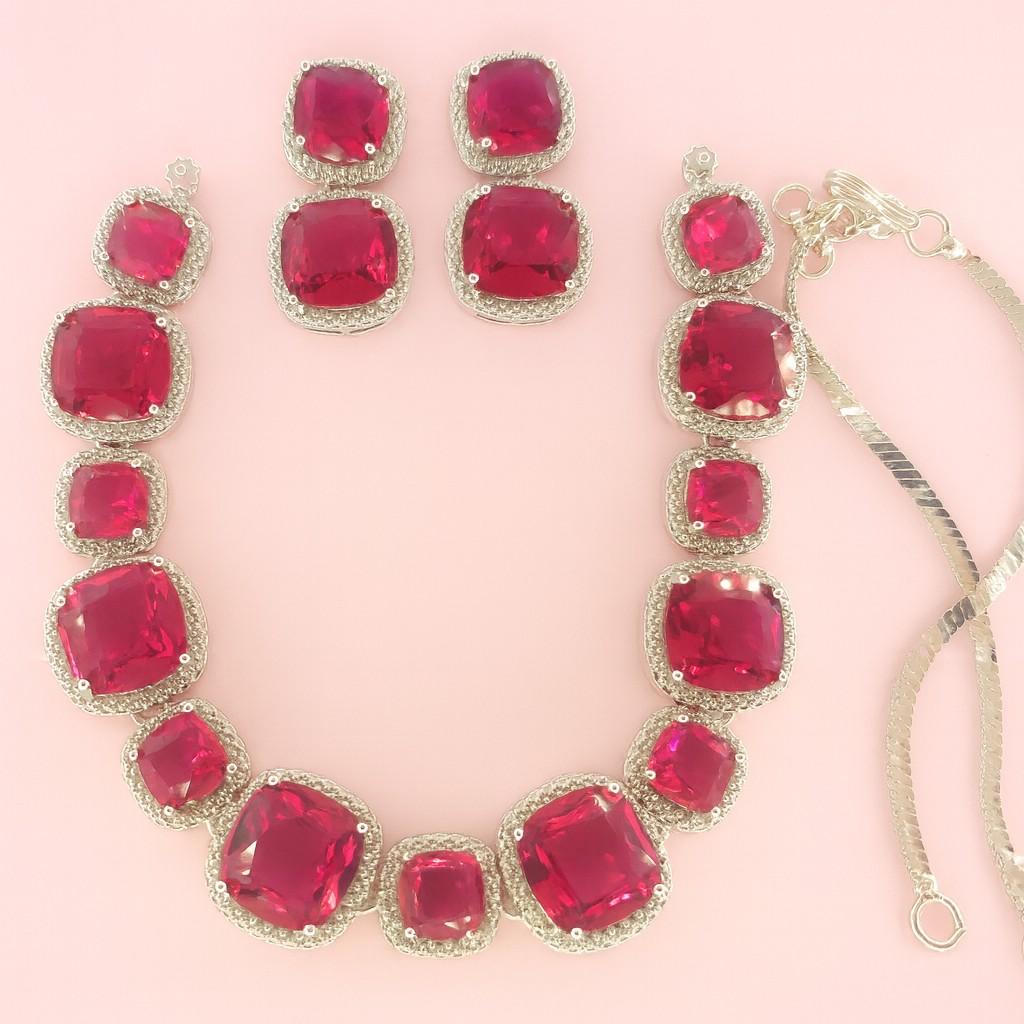 Bridal statement jewelry with cushion-cut red stones and sparkling AD accents