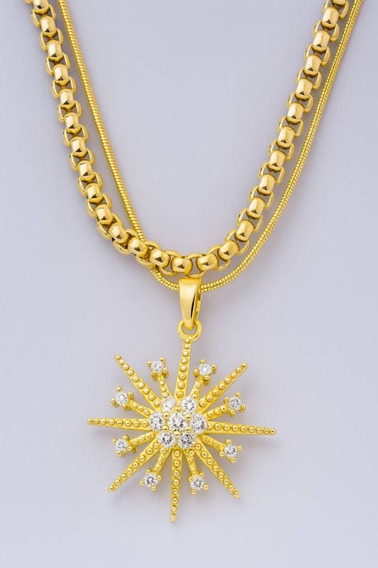 Gold-plated dual chain necklace with starburst CZ diamond pendant on soft grey background – perfect for bridal or party wear

