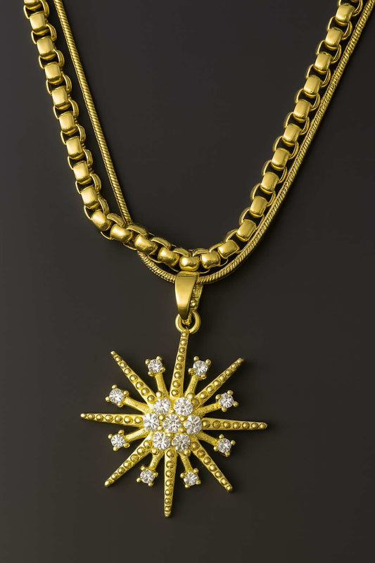 Gold-plated dual chain necklace with starburst CZ diamond pendant on soft grey background – perfect for bridal or party wear

