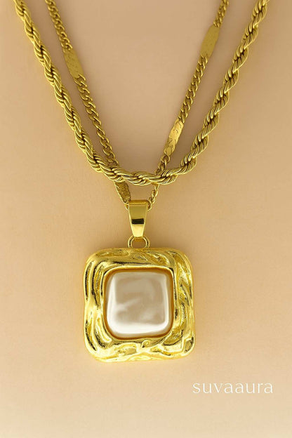 Triple-layer twisted rope gold necklace with square pearl pendant on beige background – modern Indo-western design