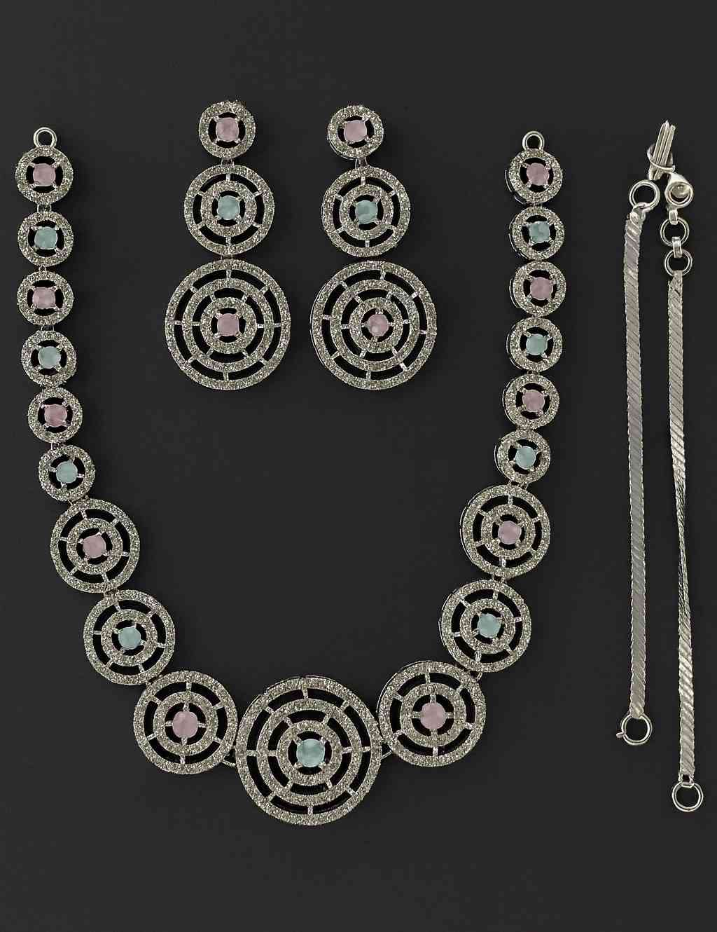 Luxury dual-tone pink and blue circular necklace set with American Diamonds in silver-tone finish, featuring matching earrings – bridal and festive wear jewelry.