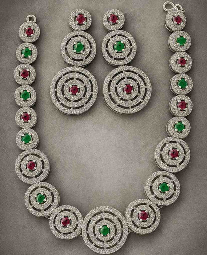 Dual tone necklace set with ruby & emerald AD stones in circular silver-tone design – includes matching earrings
