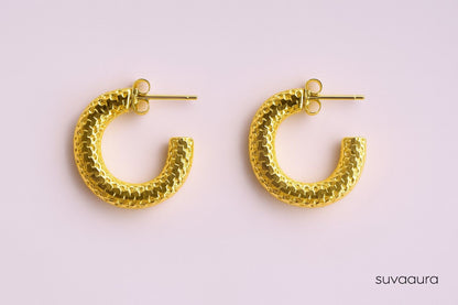 Textured gold-plated C-shaped hoop earrings on pink background – everyday style by Suvaaura