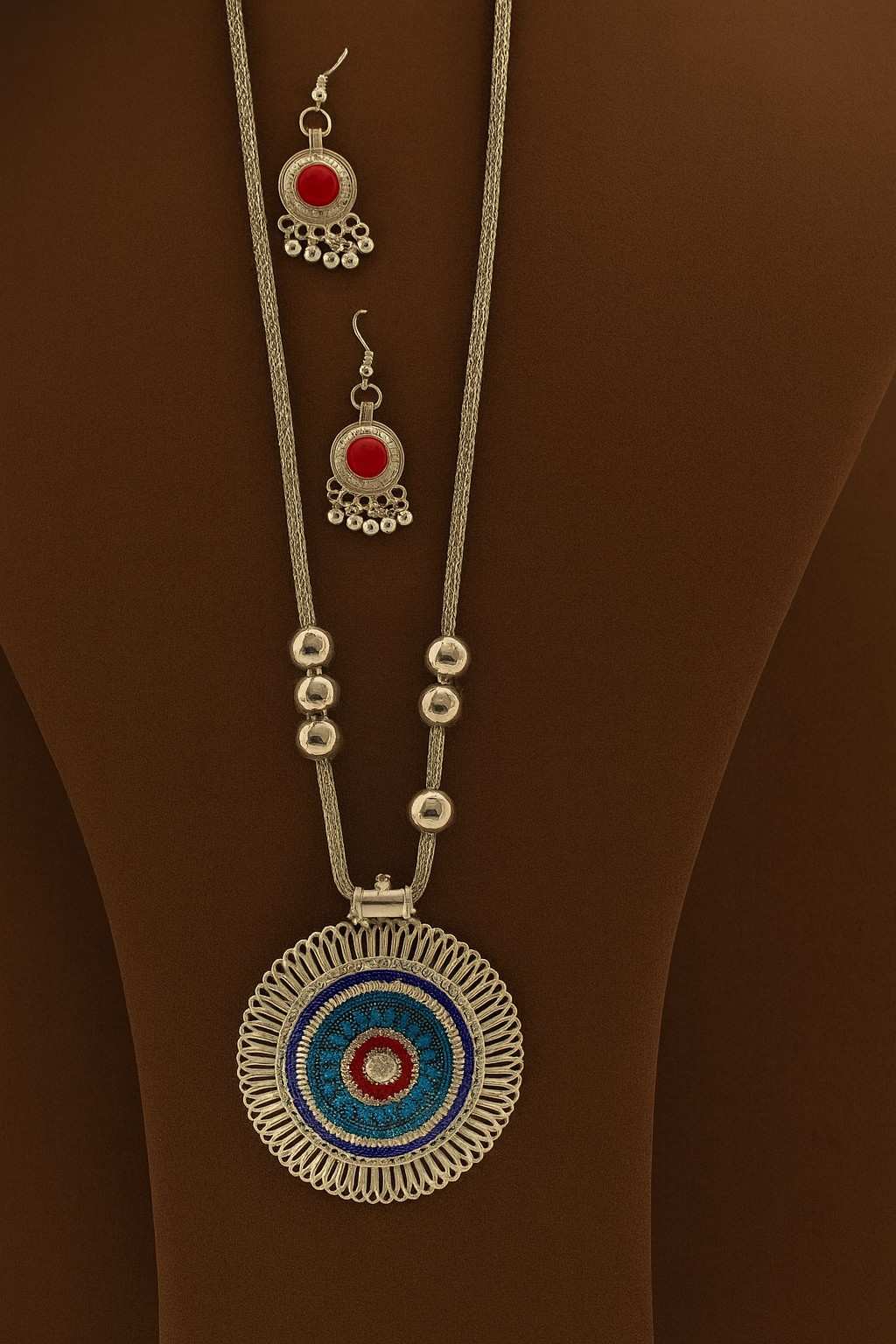 Handcrafted silver-tone long necklace with blue & red circular pendant and matching earrings – front view