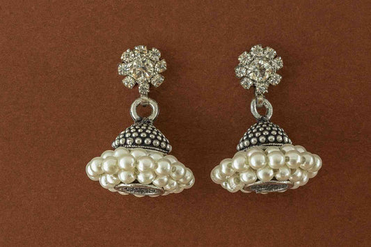Antique silver floral stud pearl cluster jhumka earrings on white background