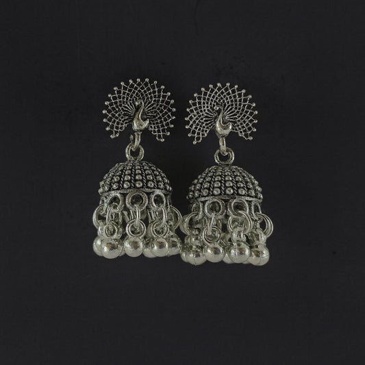 Oxidized peacock design silver-tone jhumka earrings with hanging beads on plain background