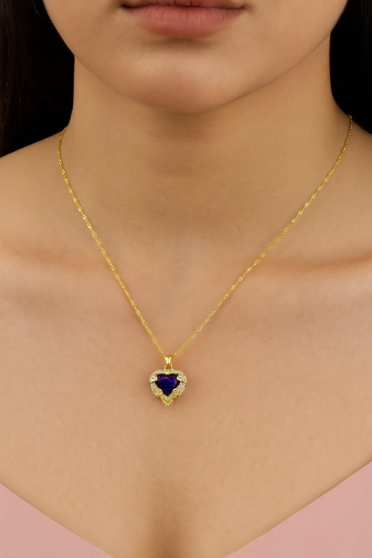 "Model wearing heart-shaped gold-tone necklace with purple stone – Suvaaura"