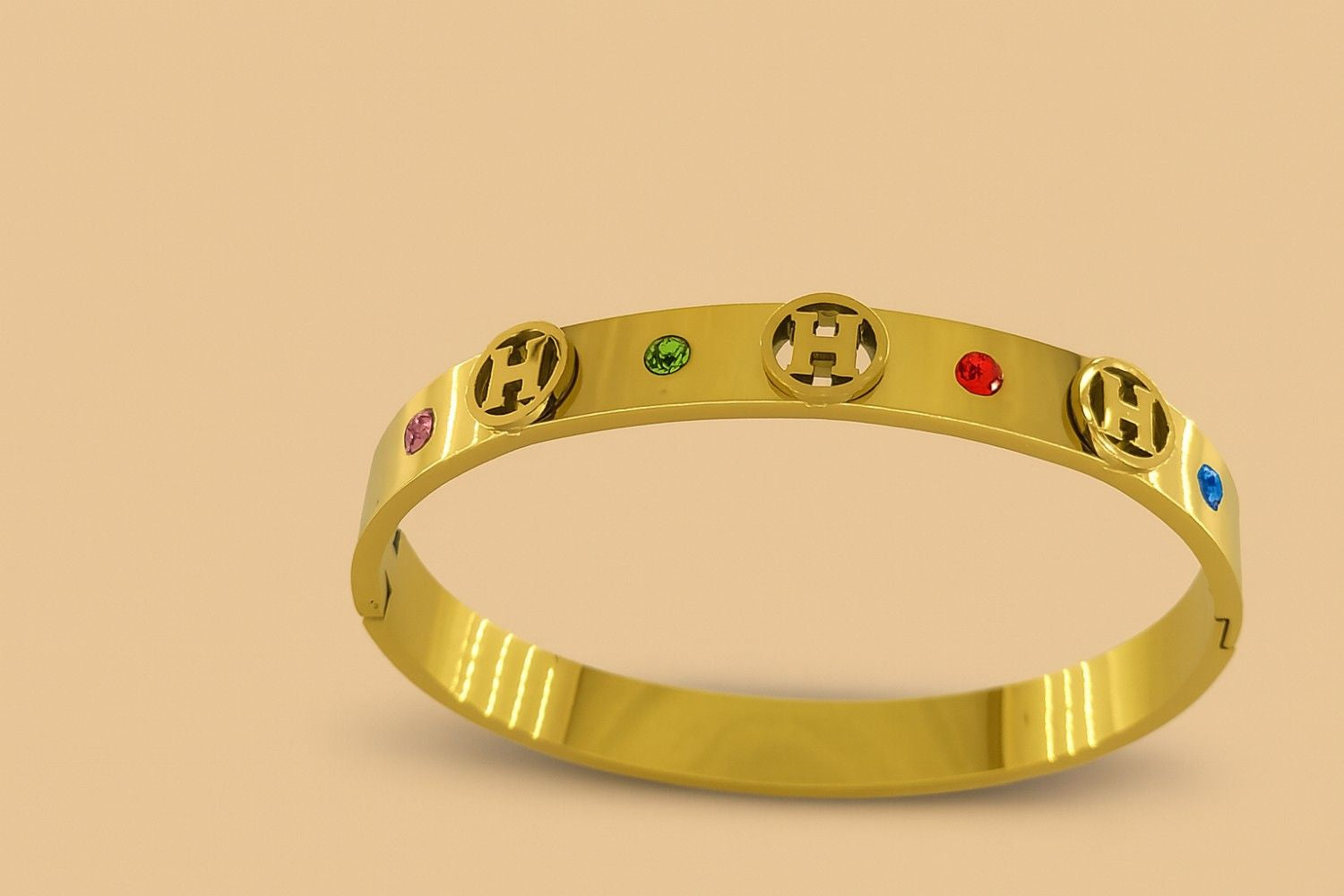 Gold-tone bracelet with multicolour crystals and cut-out design