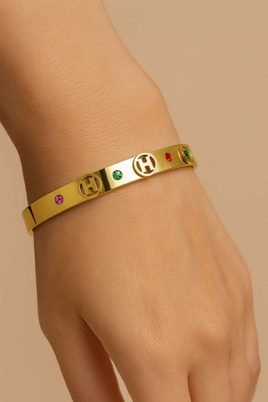 Elegant women’s bracelet with gold-tone finish and colourful stones

