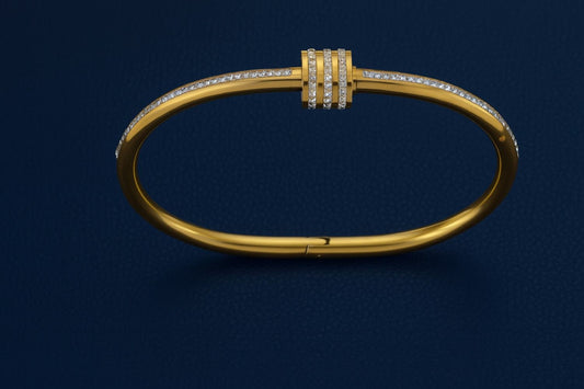 Minimalist gold-colored bracelet with three-ring centerpiece