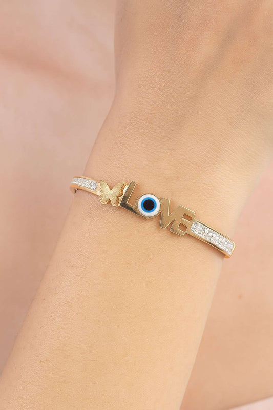Elegant women’s bracelet worn on wrist with LOVE design and butterfly charm