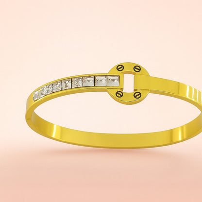Circle motif gold-tone bracelet with square stones on pink background