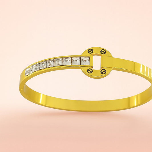 Circle motif gold-tone bracelet with square stones on pink background