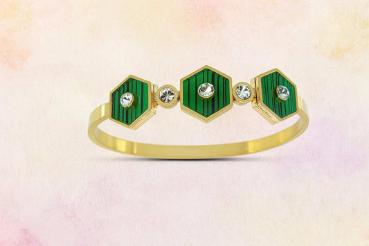 Gold-tone bracelet with green enamel hexagon design and stones