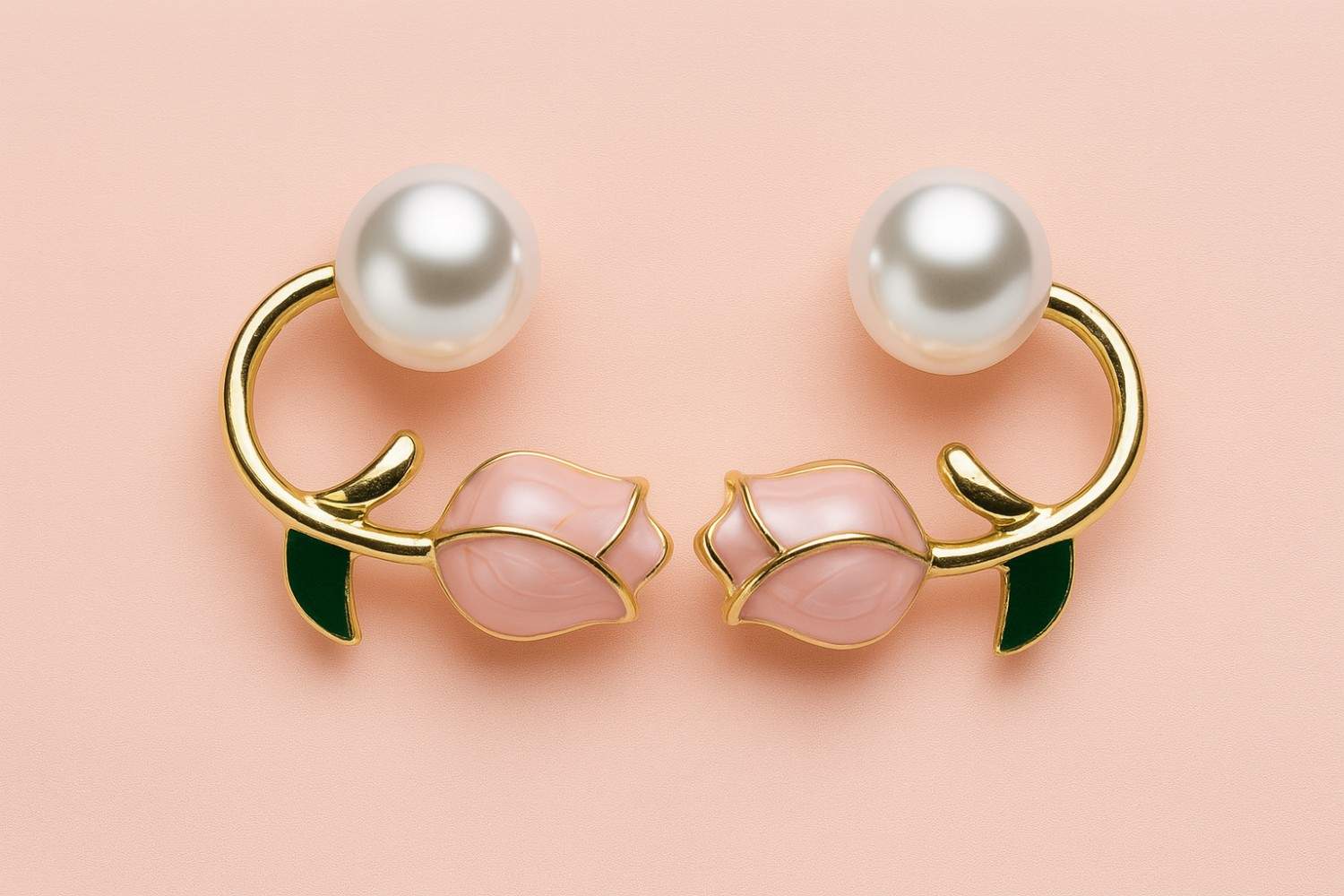 "Elegant gold-tone pearl and pink rose bud earrings with green enamel leaf detail on pastel background"