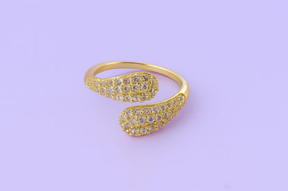 "Gold-tone teardrop crystal ring with twin ends and sparkling stones"