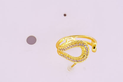 "Gold-tone open teardrop ring with embedded sparkling crystals"